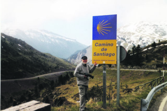 Manfred Görke auf dem Somport-Pass, Teil des Jakobsweges in den spanischen Pyrenäen. Auf dem Schild steht das Pilgersymbol: die Jakobsmuschel.
