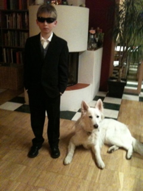 Man in black with dog in white