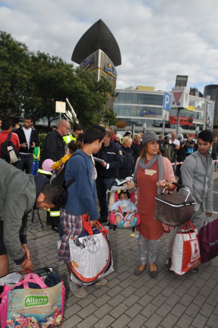 Helferinnen trugen Familien die Babys zum Bus, der die Flüchtlinge in eine Unterkunft brachte.