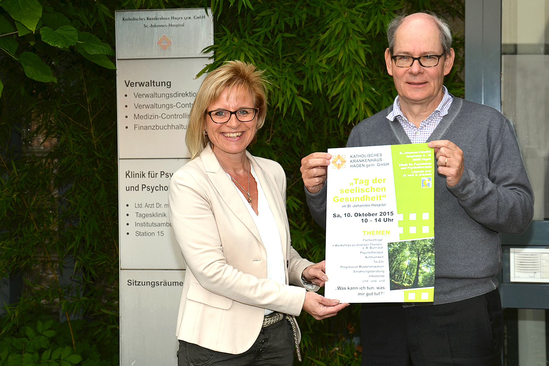 Der Chefarzt der Psychiatrie und Psychotherapie, Dr. med. Nikolaus Grünherz, und die Referentin für
Öffentlichkeitsarbeit, Martina Schewe-Glembin, mit
Plakat der Veranstaltung.