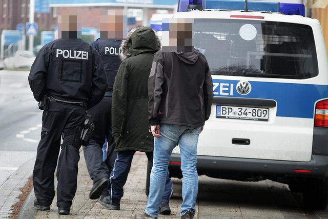 Polizisten bringen den Verdächtigen zum Auto. | Foto: Magalski