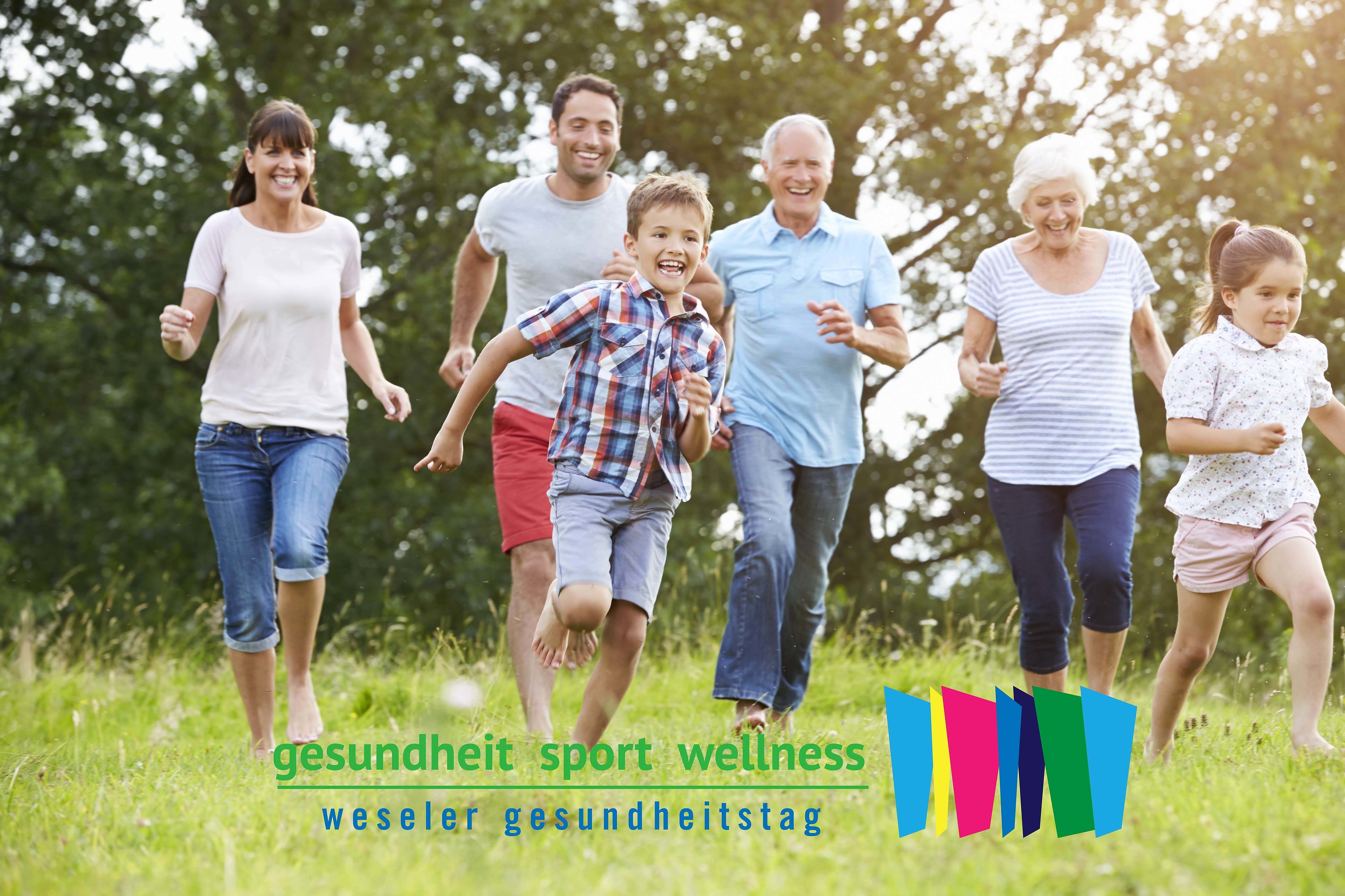 Multi Generation Family Running Across Field Together