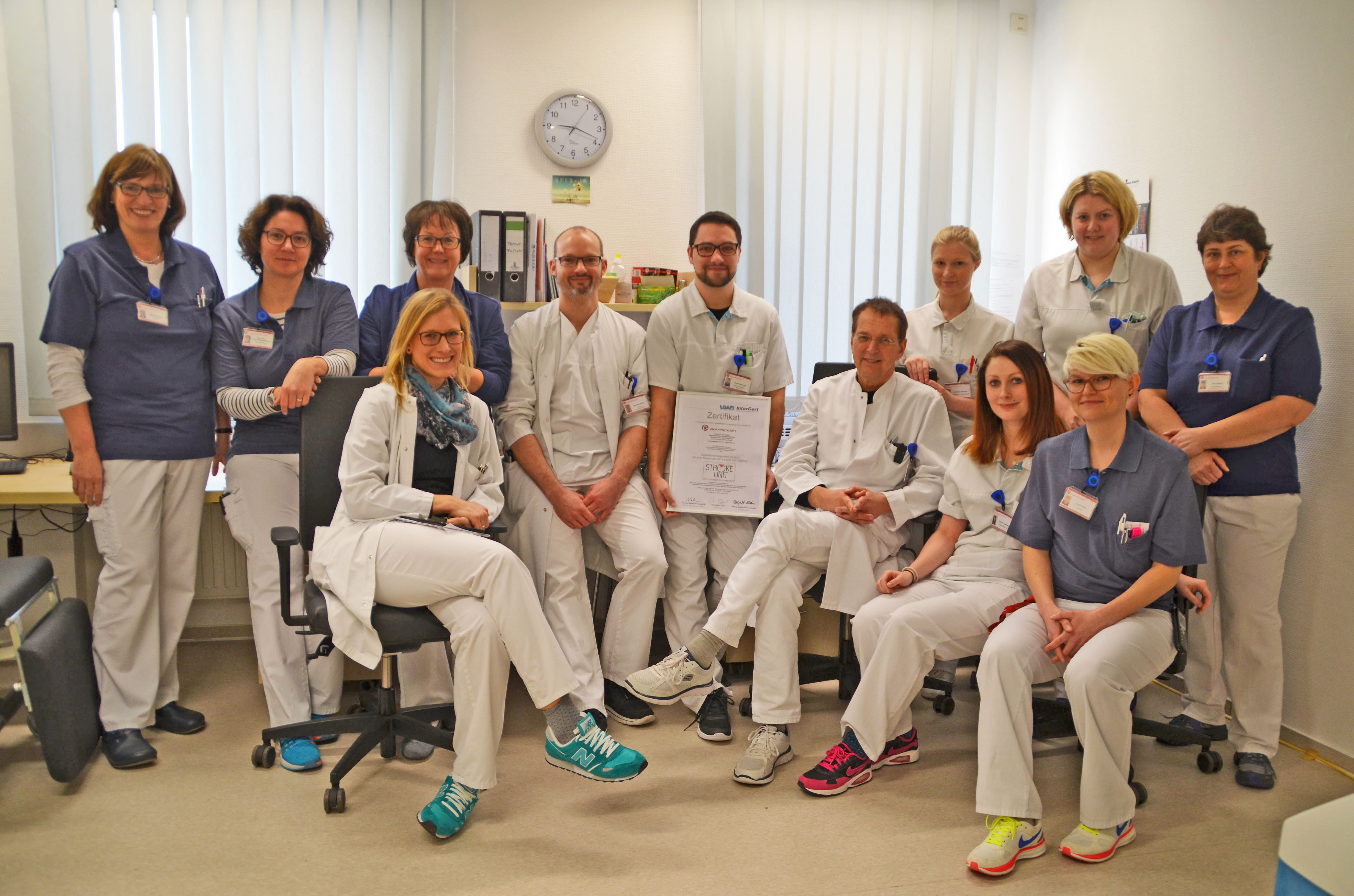 Das Team der Stroke-Unit v. l. n. r.: Sabine Hintemann (Logopädin), Kathrin Kleine-Nathland (Neuropsychologin), Jutta Markowski (Ltd. Ergotherapeutin), davor Hilke Lautner (Assistenzärztin), Bernhard Wallner (Oberarzt), Daniel Dworaczyk (Gesundheits- und Krankheitspfleger) mit dem Zertifikat, Dr. Reinhold Dux (Chefarzt), Christina Lehmberg (Gesundheits- und Krankenpflegerin), Henryke Vogelsand (Gesundheits- und Krankenpflegerin), Kristin Hotze (Gesundheits- und Krankenpflegerin), davor Carolin Kosok (Logopä
