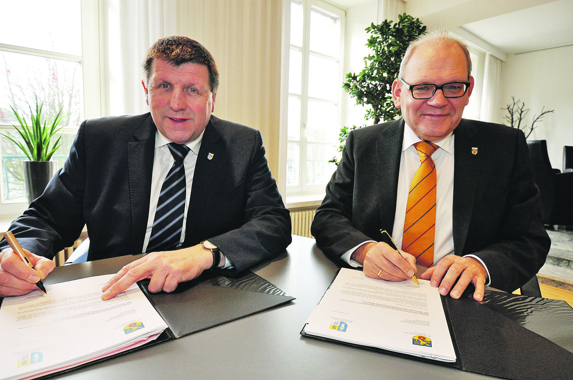 Die Bürgermeister Ulrich Franken (links) und Ulrich Knickrehm haben die Vereinbarung für den Gewerbepark Weeze - Goch unterzeichnet.
