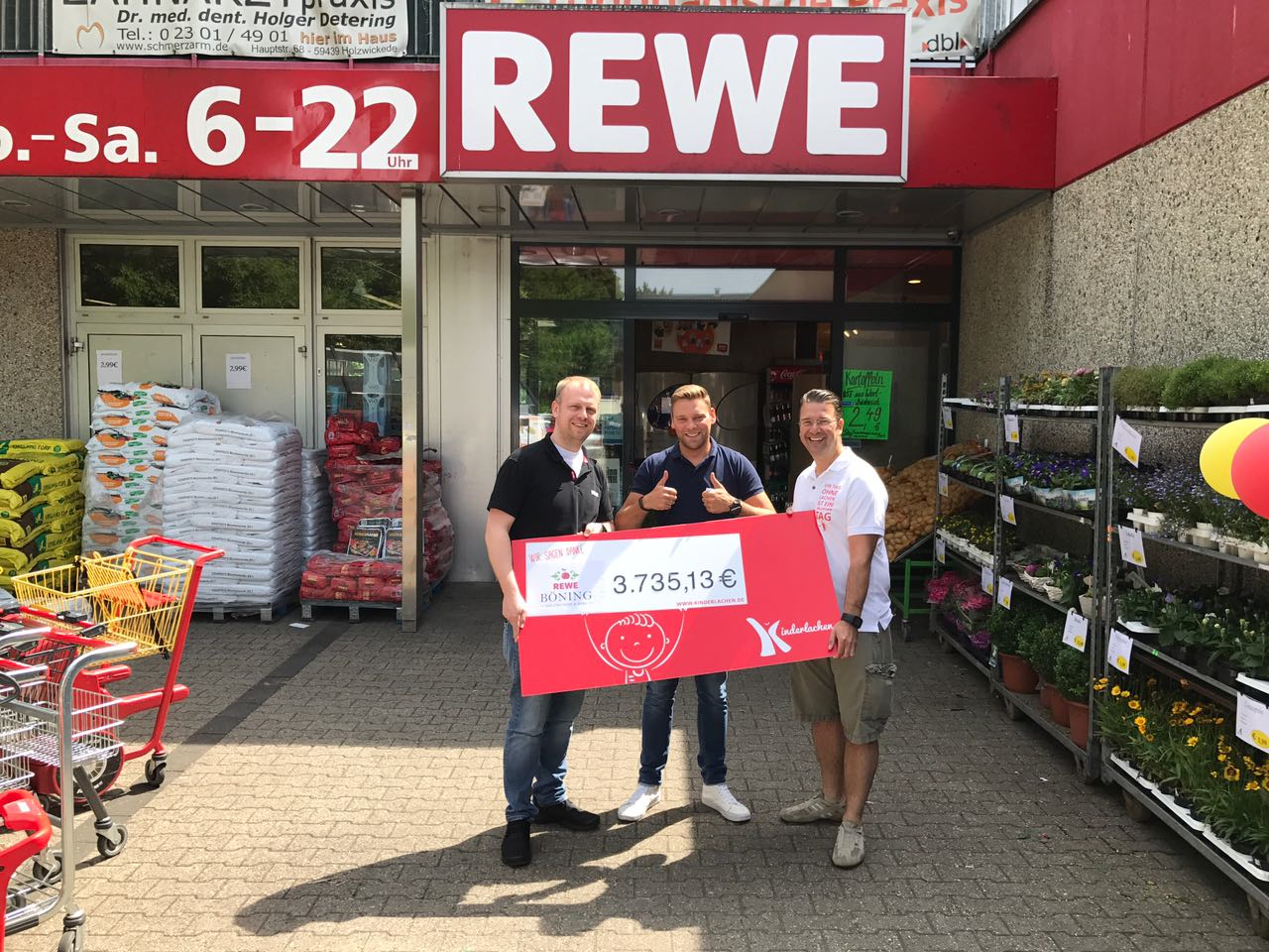 Nun übergaben Markt-Inhaber Florian Böning und Christian Barnick, Rewe Dortmund, den symbolischen Spendenscheck in Höhe von rund 3.735 Euro an Kinderlachen-Mitgründer Marc Peine.