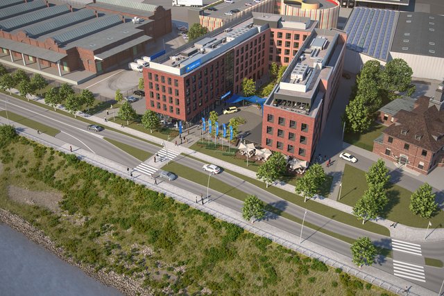 Der südlich gelegene Flügel des Hotels bildet den künftigen Bürokomplex mit Sportpark und Wellness-Bereich, das restliche „L“ des u-förmigen Gesamtgebäudes ist das eigentliche Hotel. Mit ihrer Ziegeloptik orientiert sich die Fassade an den angrenzenden Shell-Gebäuden. | Foto: DIVAG LO7