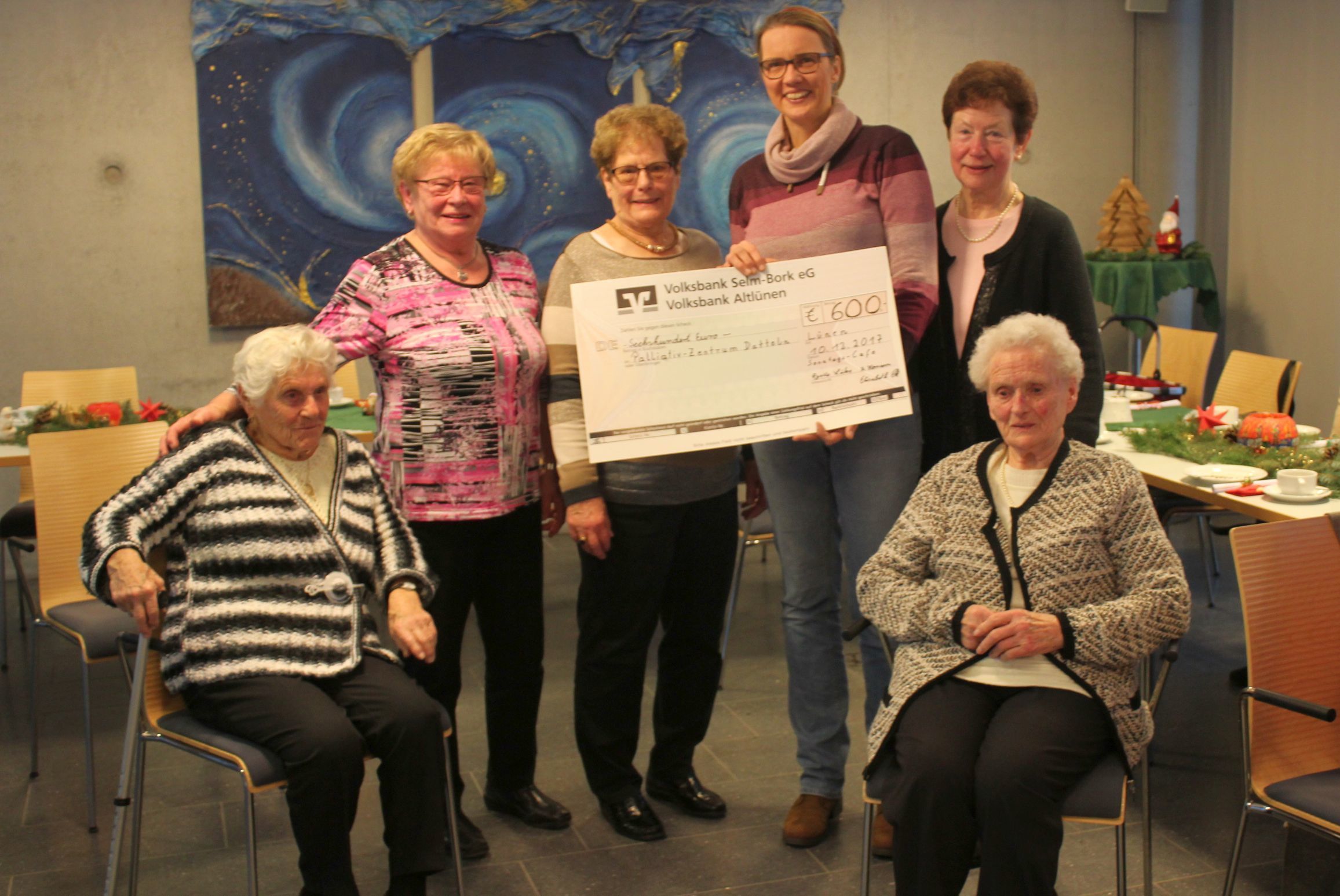 Nicole Sasse (4.v.l.) freut sich über den Spendenscheck von Elisabeth Ott (stehend, v.l.), Ursula Homann und Agathe Lücke.