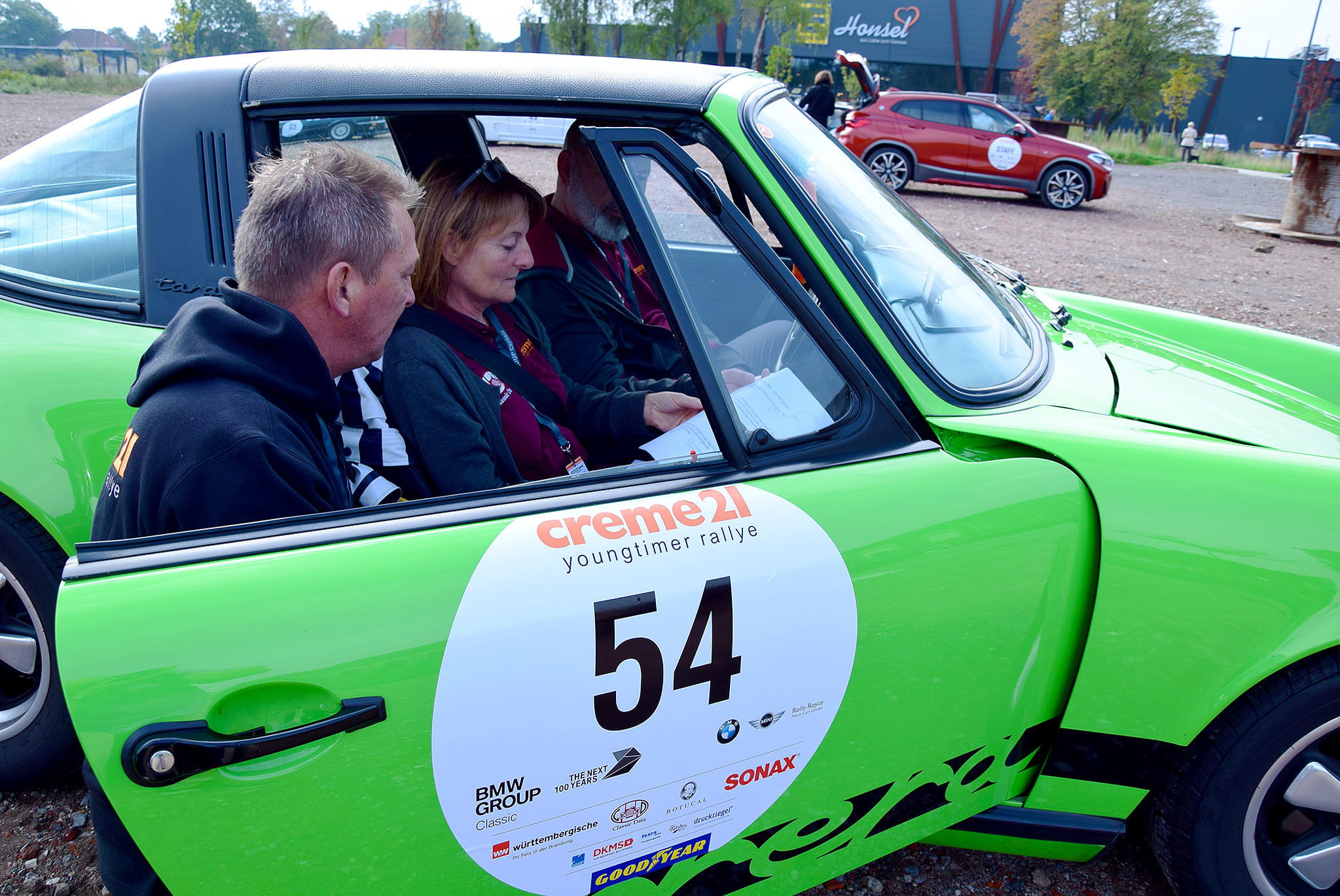 Checkpoint Leopold: Werner Süring vom Creme21-Team nimmt auf dem Parkplatz zwischen Edeka Honsel und dem LEO die Zeiten die Teilnehmer, verteilt Gummibärchen und sorgt bei den Rallyefahrern für gute Laune.
