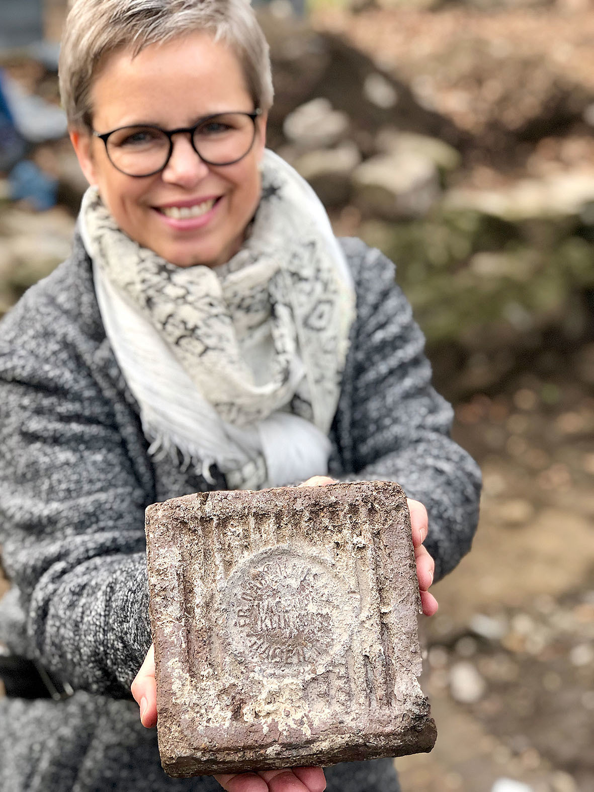 Ina Hanemann, Leiterin der Unteren Denkmalbehörde, mit einem Ziegelstein aus einer Hagener Ziegelei, den die Archäologen in der Buddhagrube entdeckt haben.