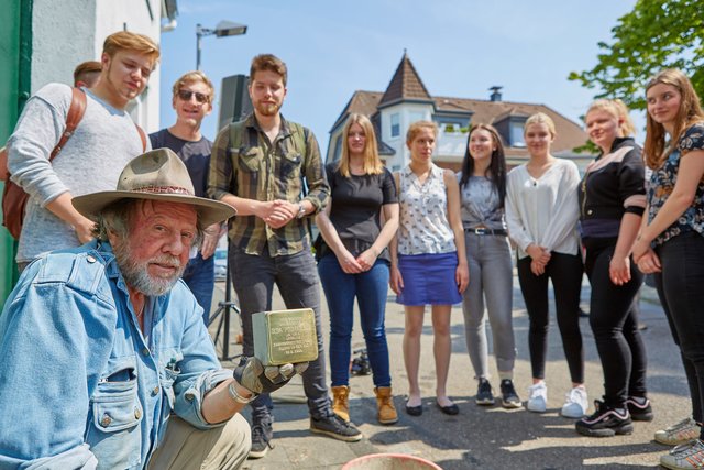 Künstler Gunter Deming mit einigen der Schülerinnen und Schüler der Peter-Ustinov-Gesamtschule, die auch die jüngste Stolpersteinverlegung wieder thematisch mitbegleiteten.
Foto: Michael Hotopp