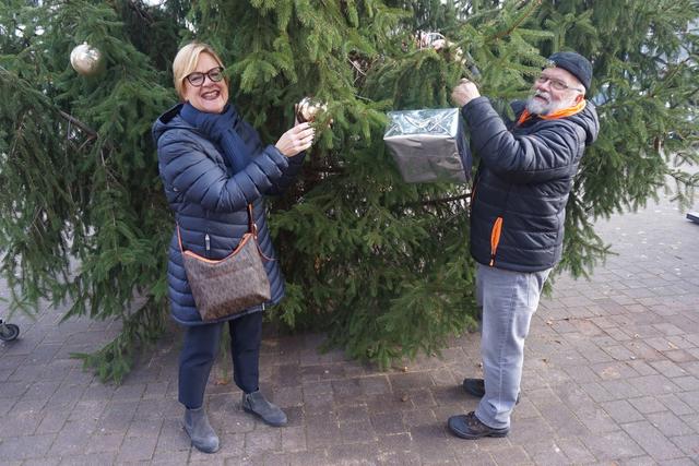 Monika Fontaine und Günter Kalla können beim Schmücken nur die unteren Äste erreichen.